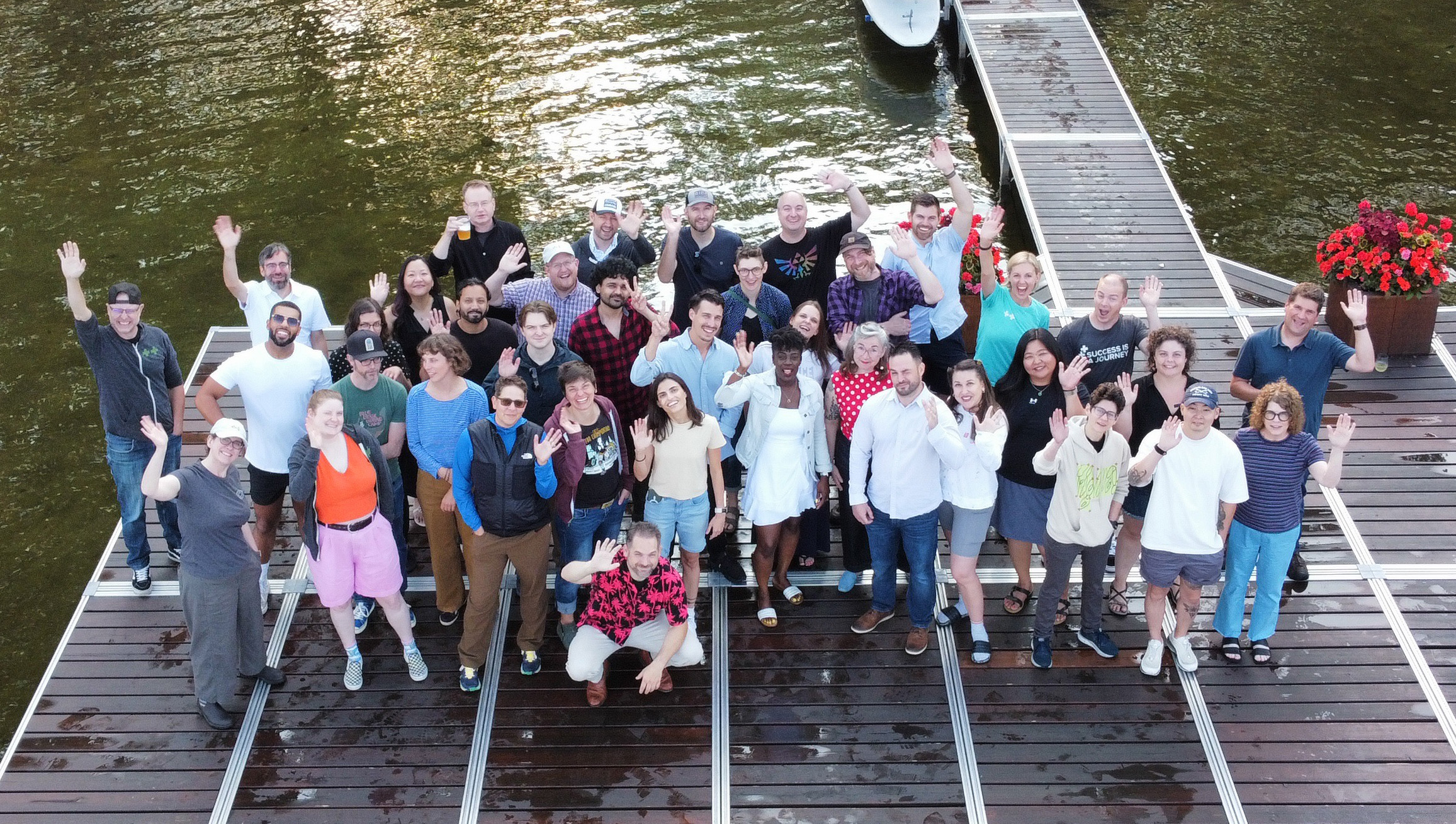 Photo from above of the Palantir team standing on a dock