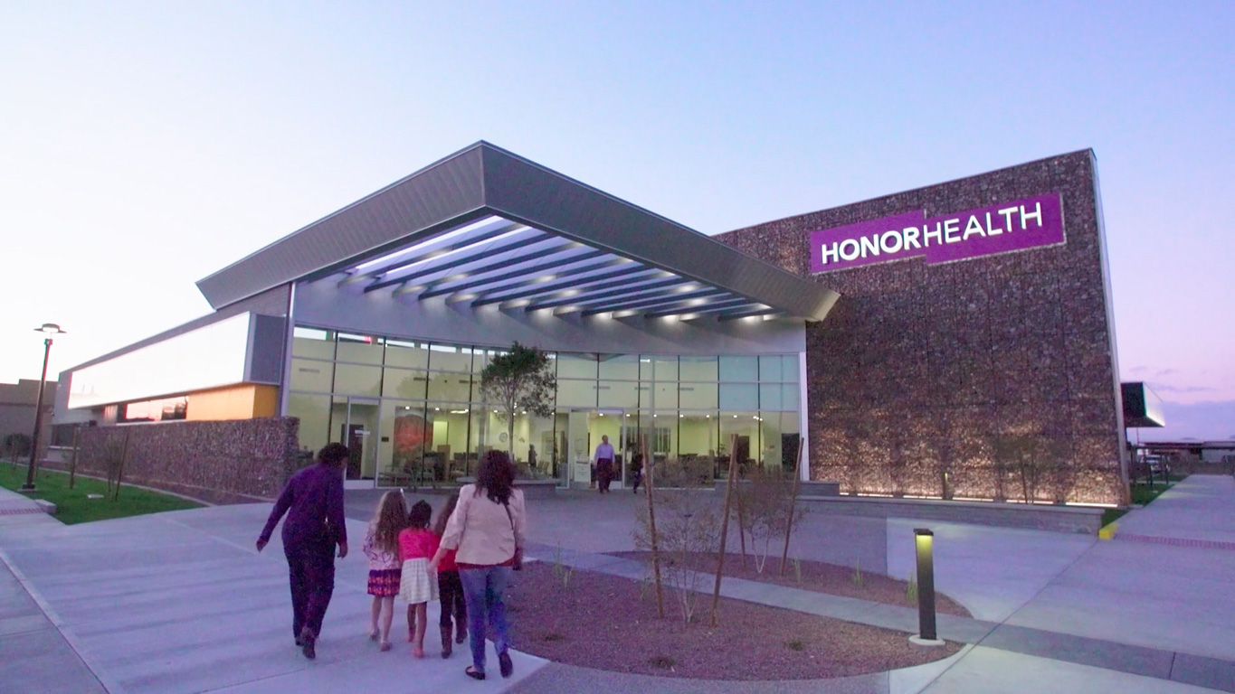 Photo of a family walking toward an HonorHealth facility