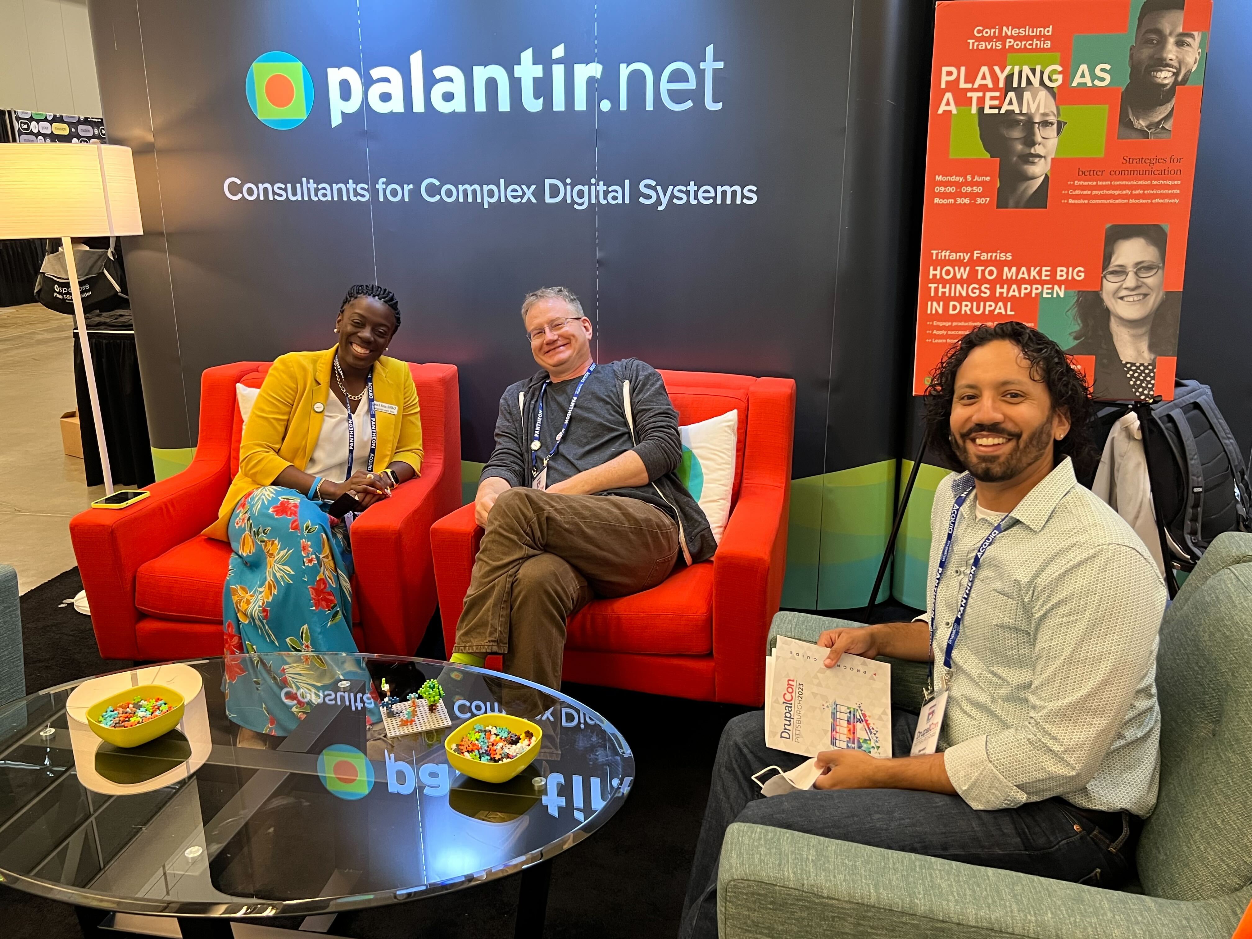 Photo of Adwoa, Ken, and Steven at the Palantir.net booth at DrupalCon Pittsburgh